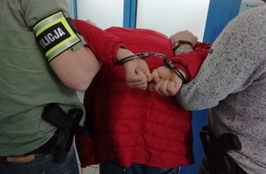 policjanci prowadzą  podejrzanego sprawcę kradzieży