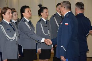 zdjęcie policjantów z uroczystości obchodów święta Policji w Bełchatowie. Policjanci odbierają awanse z rąk Komendanta Wojewódzkiego Policji w Lodzi.