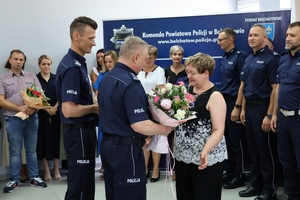 uroczyste spotkanie policjantów i pracowników cywilnych Policji. W auli komendy uroczystość służbowa związana z odejściem na emeryturę pracownicy cywilnej. Komendanci składają życzenia kobiecie.