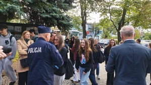 zdjęcie z akcji Odblaski ratują życie, która była wspólną akcją Policji i Starostwa Powiatowego w ramach kampanii „Bezpieczna droga do szkoły”. Na zdjęciu Komendant i Starosta Bełchatowski,  przed budynkiem szkoły. Komendant i Starosta rozdają uczniom odblaski.